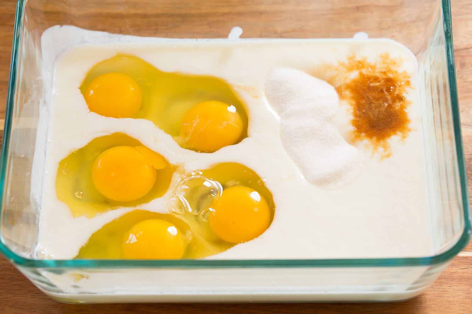 French toast custard ingredients shown in glass dish before mixing.
