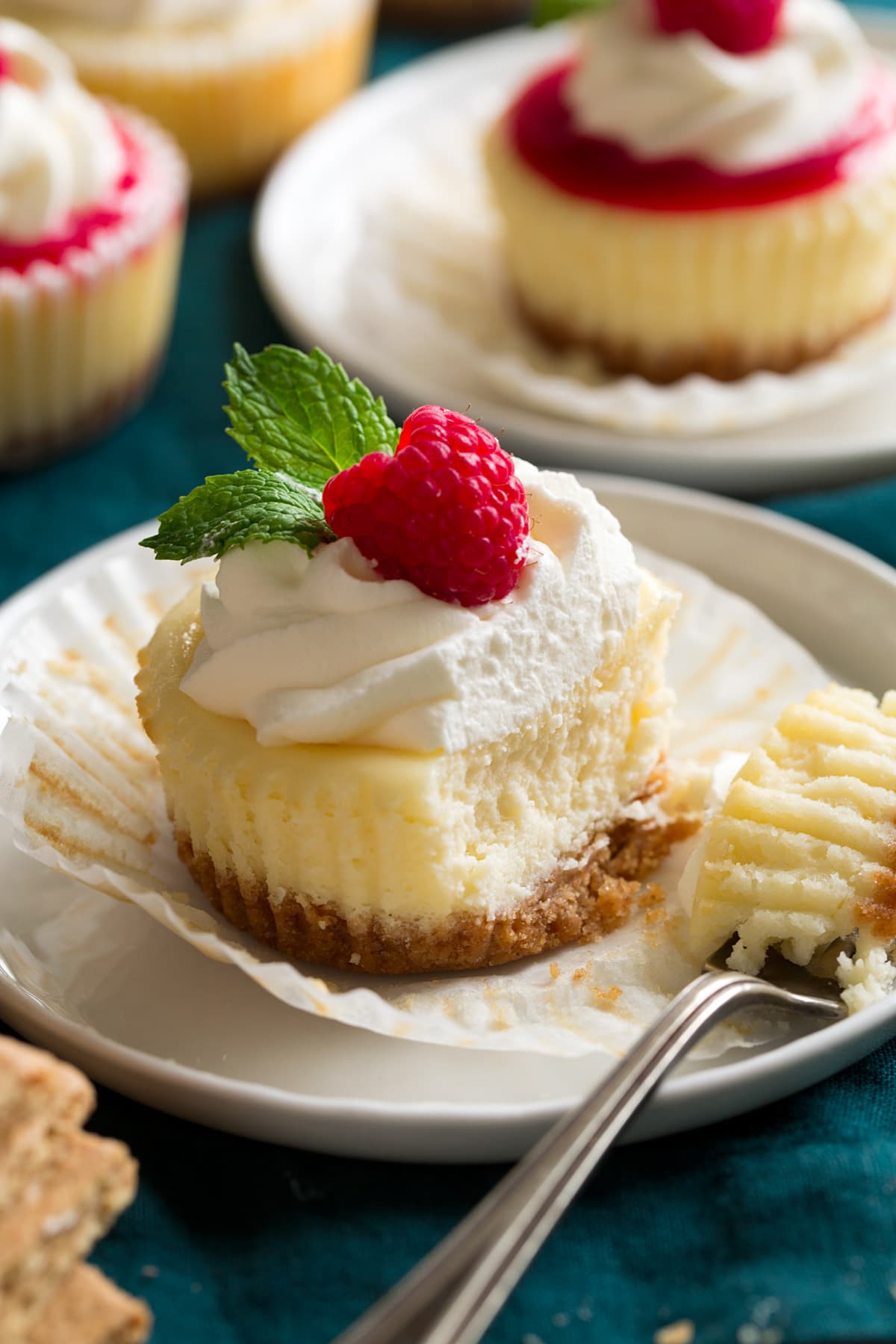 Mini cheesecake cut into with a work to show interior texture.