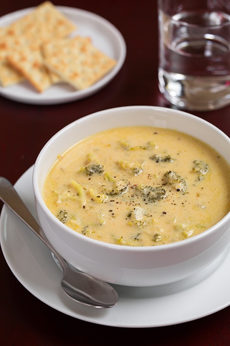 Slow Cooker Broccoli Cheese Soup in a white bowl with a spoon