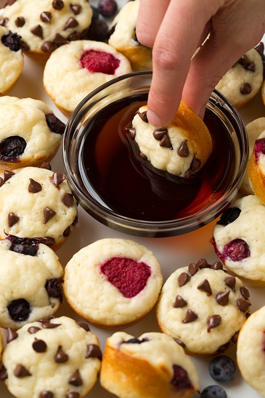 dunking a mini pancake bite into maple syrup
