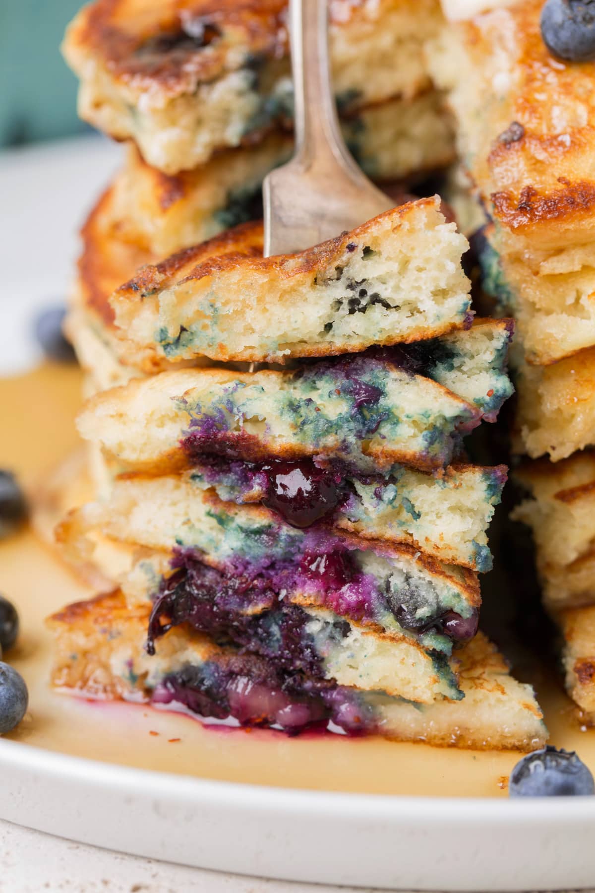 Stack of pancakes cut into, showing close up.