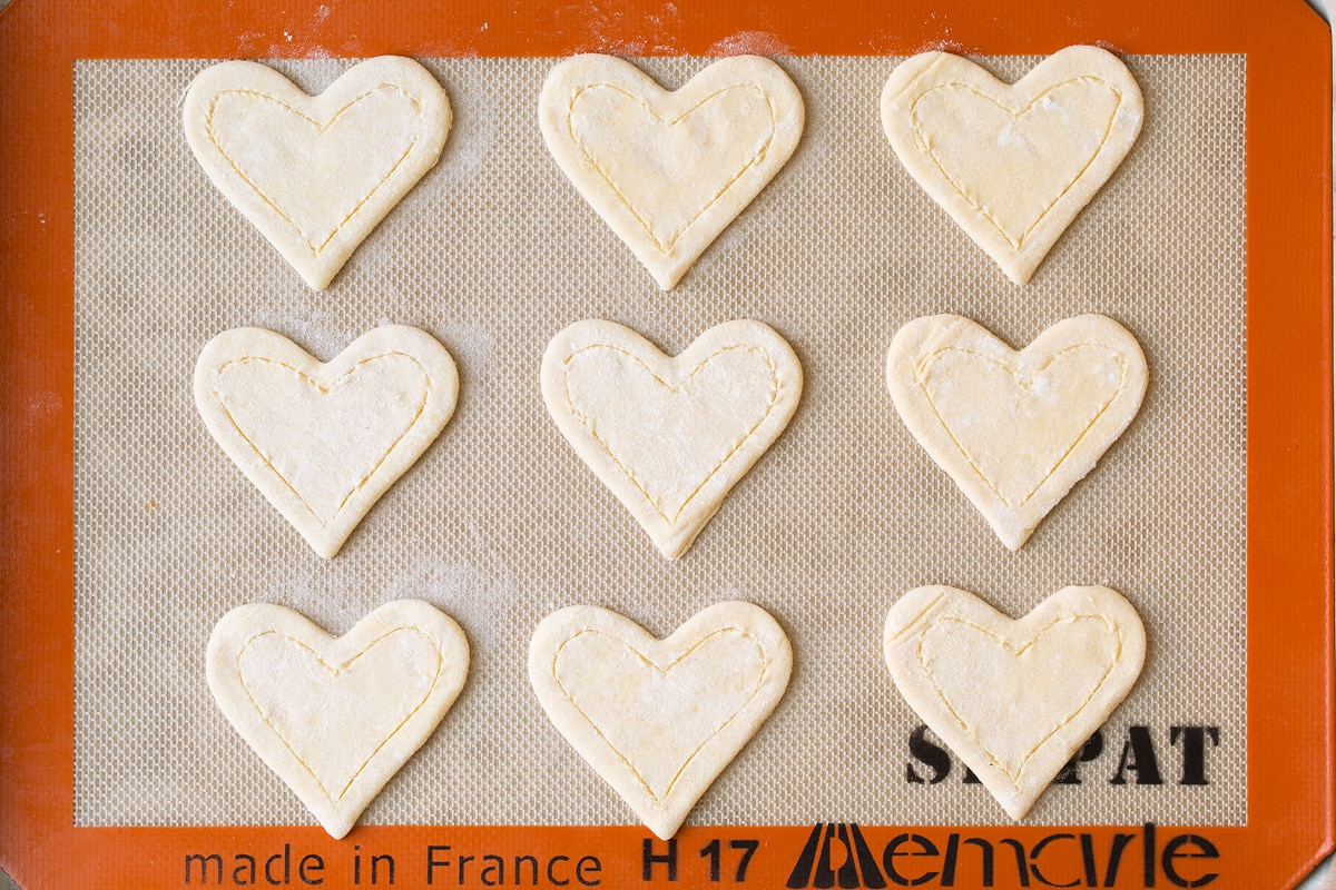 Cut puff pastry on a silicone line baking sheet.
