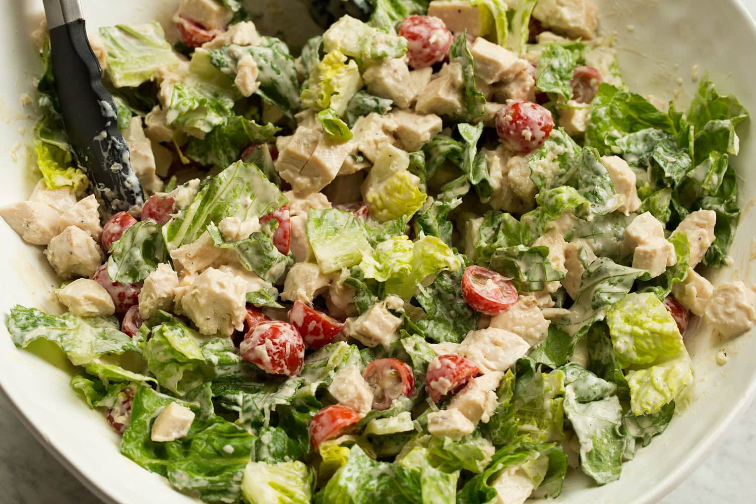 Toss chicken caesar salad and dressing.