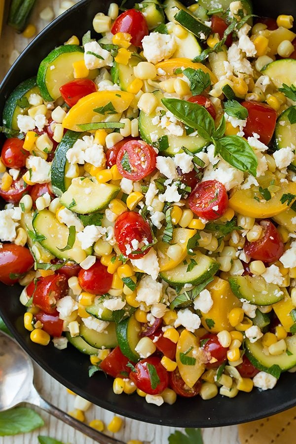 Zucchini and squash salad in a black serving bowl.