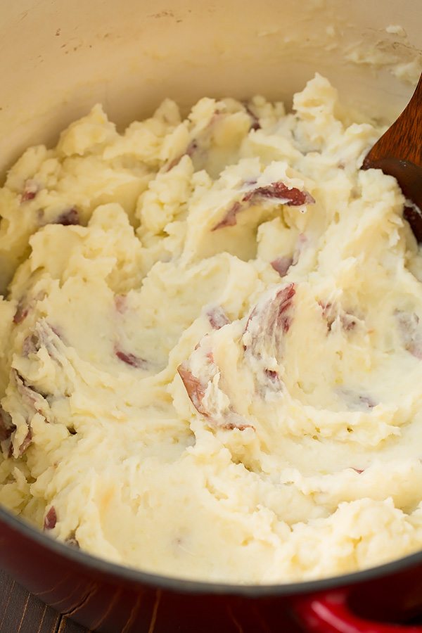 Red potatoes after being mashed in a pot.