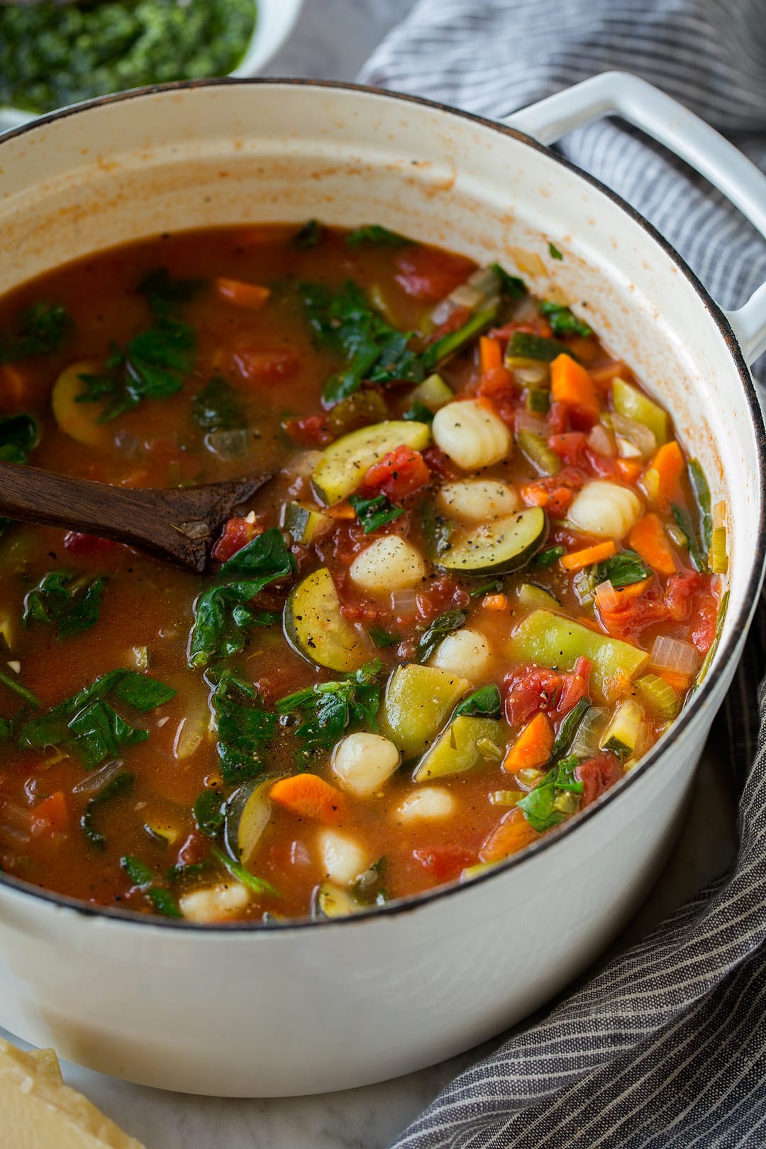 Gnocchi Vegetable Soup with in a large white enamel pot