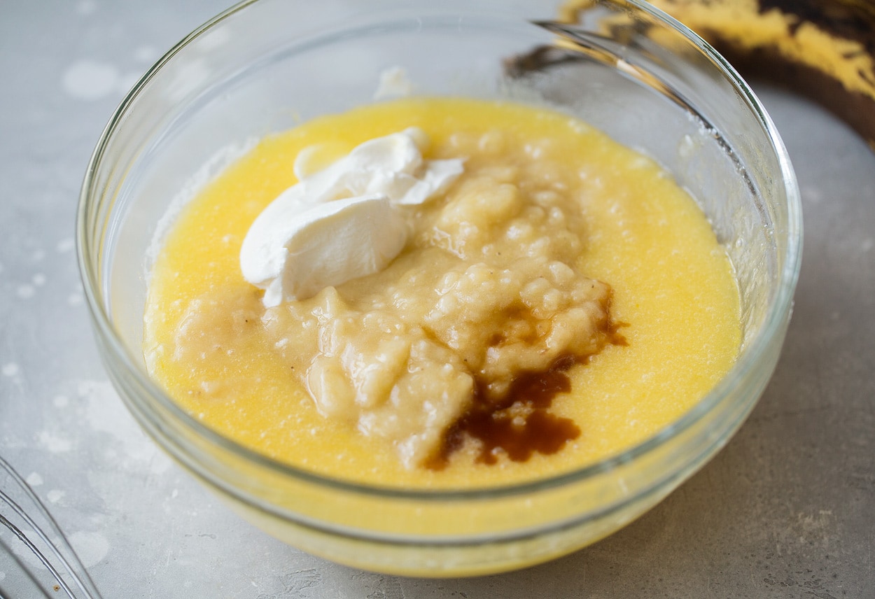 bananas vanilla and sour cream for banana bread in a bowl