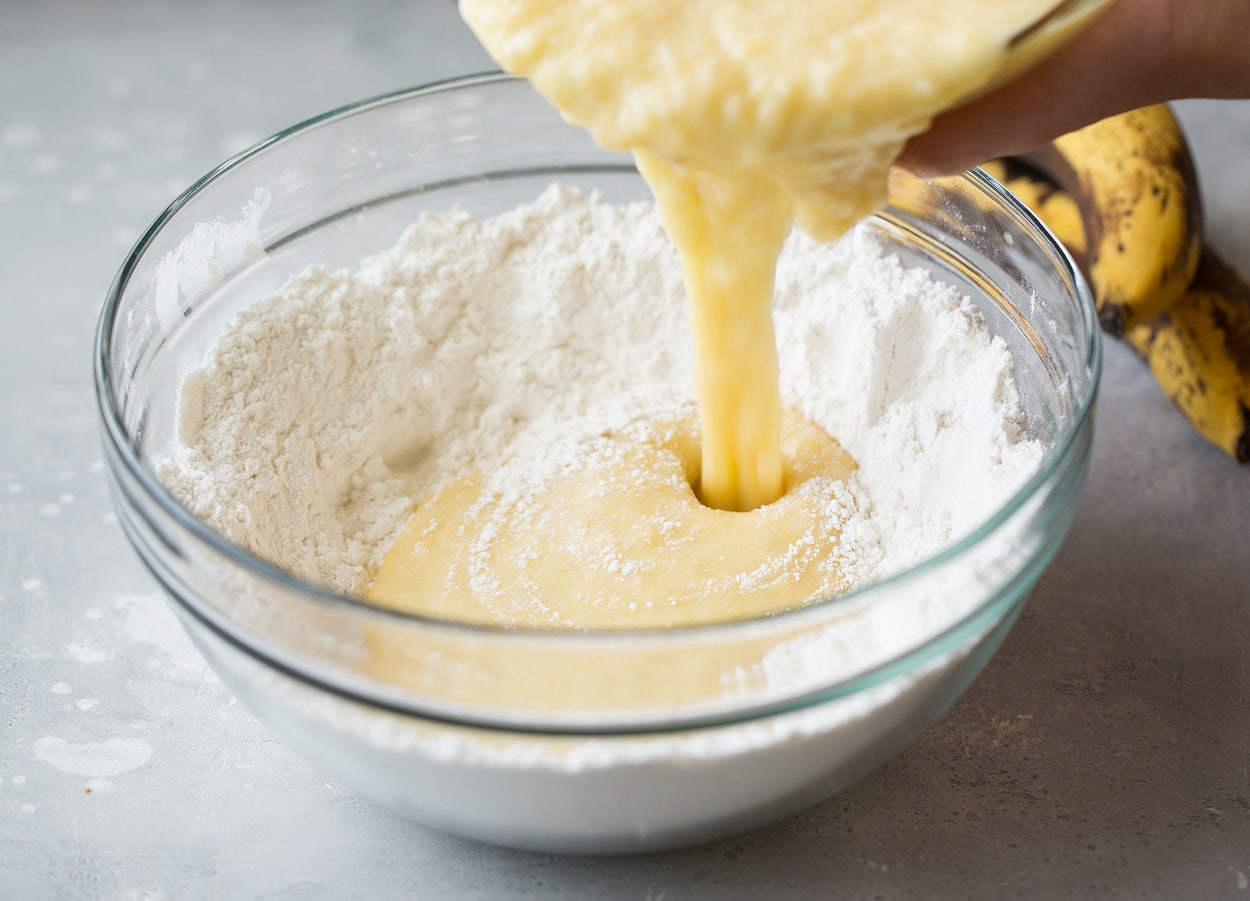 wet ingredients and dry ingredients being incorporated for banana bread