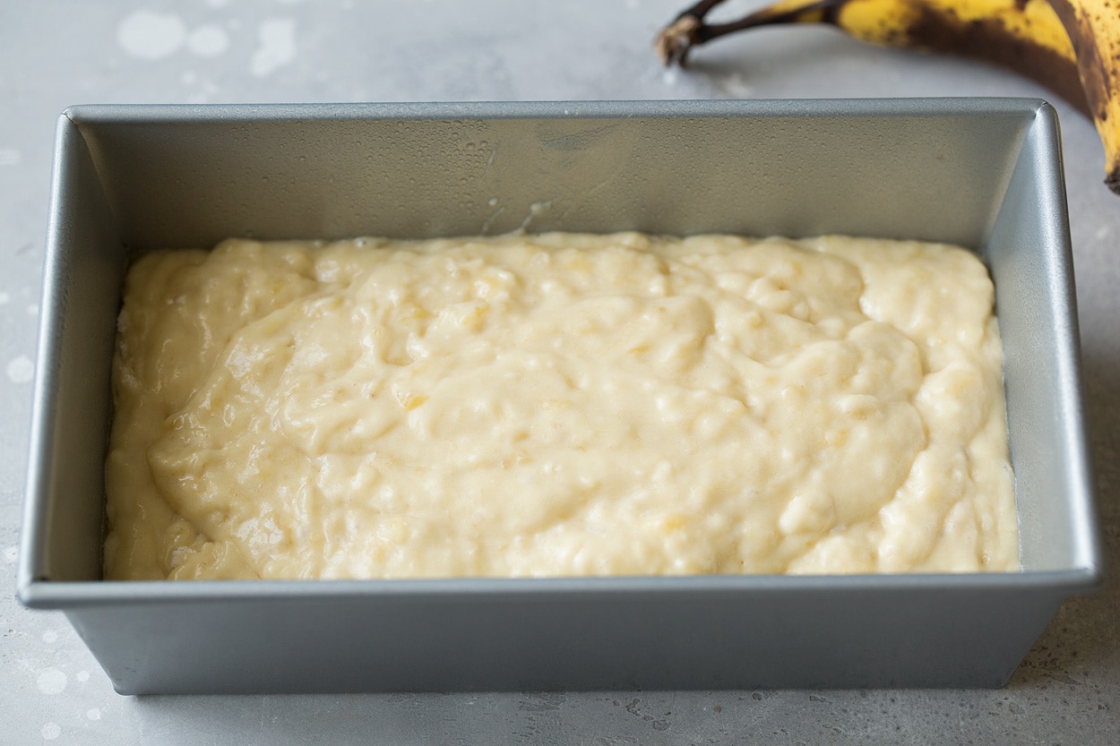 banana bread mixture poured into loaf pan