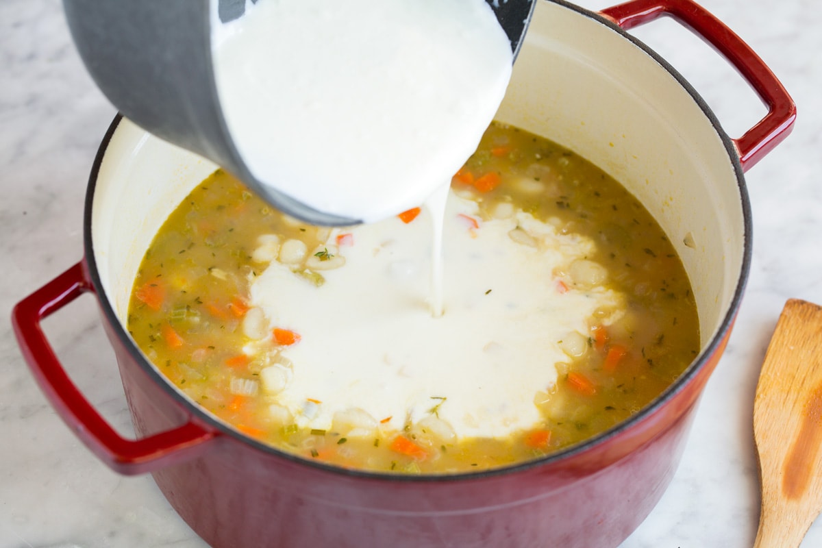 Adding thickened milk mixture into pot.