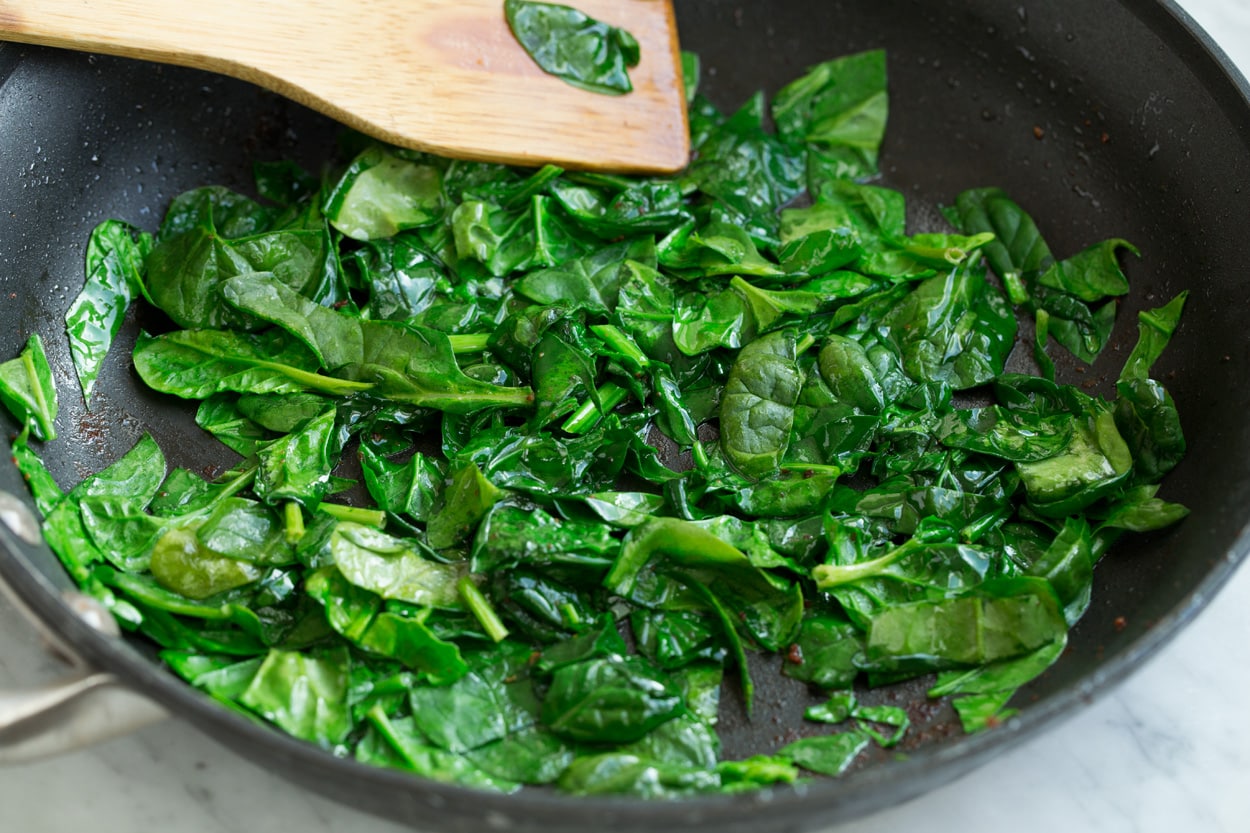 Sauteeing spinach in a large skillet to add to frittata.
