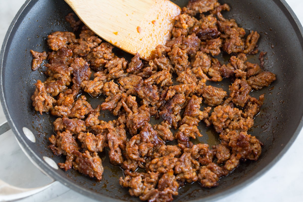 sauteeing chorizo in a skillet until browned