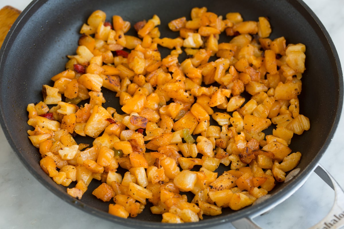sautéing diced potatoes in a skillet 