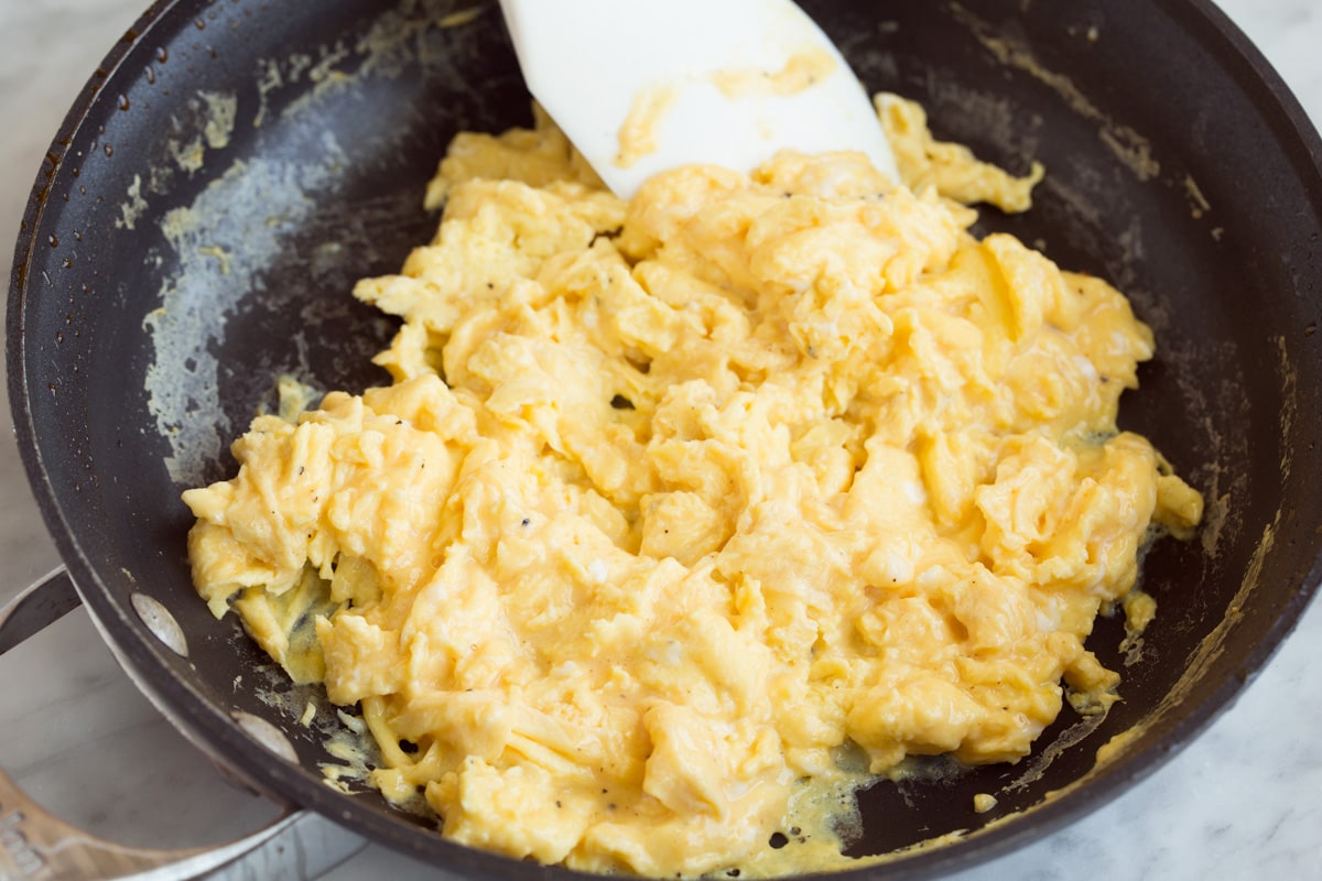 cooking scrambled eggs in a skillet