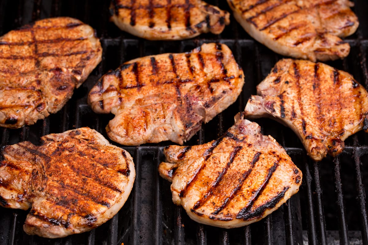 pork chops on a grill shown after finished cooking