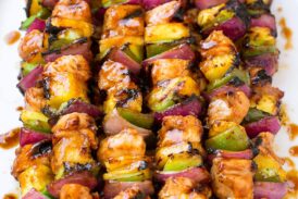 Grilled Hawaiian Chicken Kebabs on a white platter.