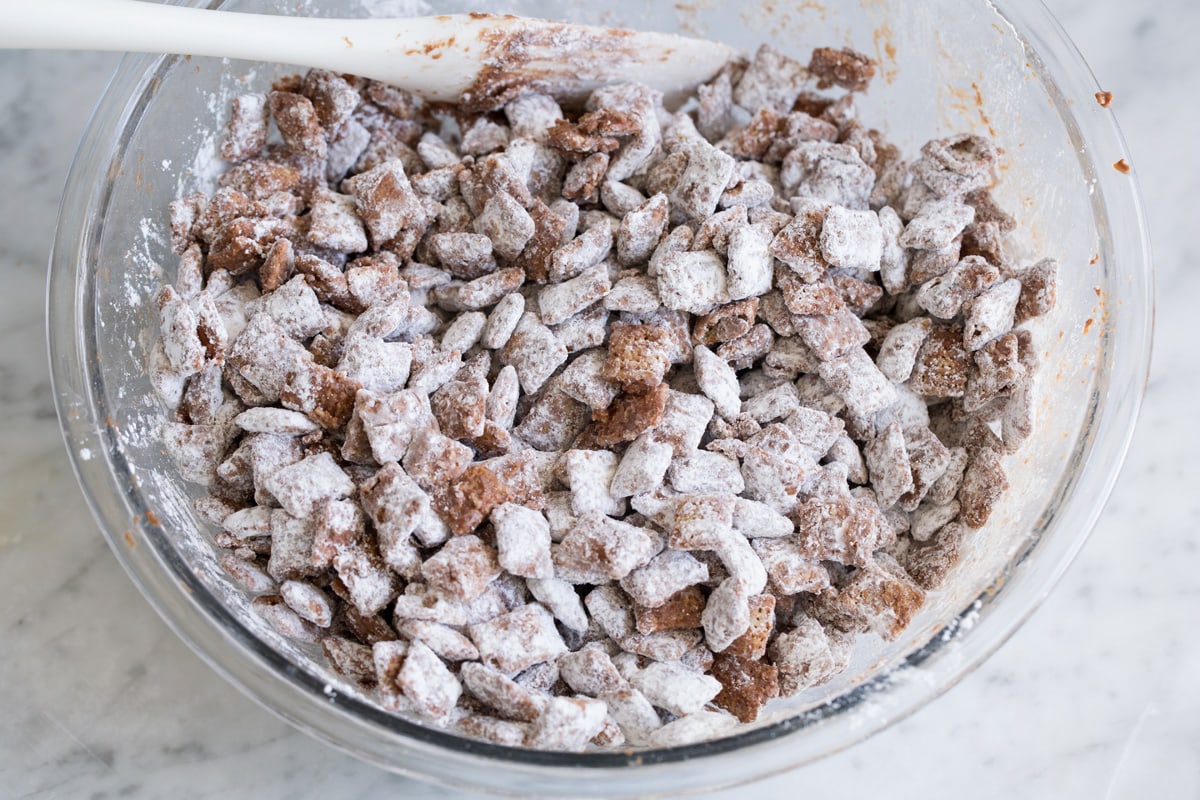 Finished bowl of muddy buddies in mixing bowl.