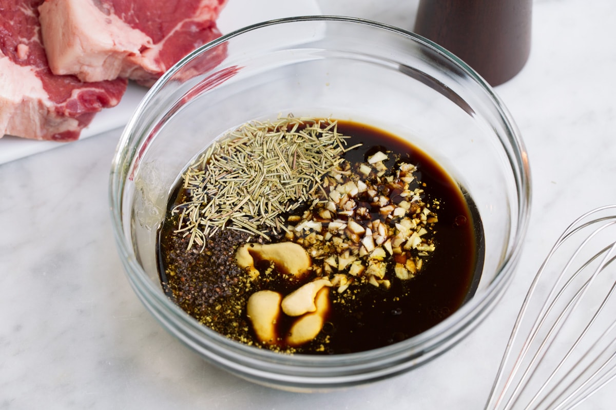 Showing how to make steak marinade. Mixing ingredients in a glass mixing bowl.