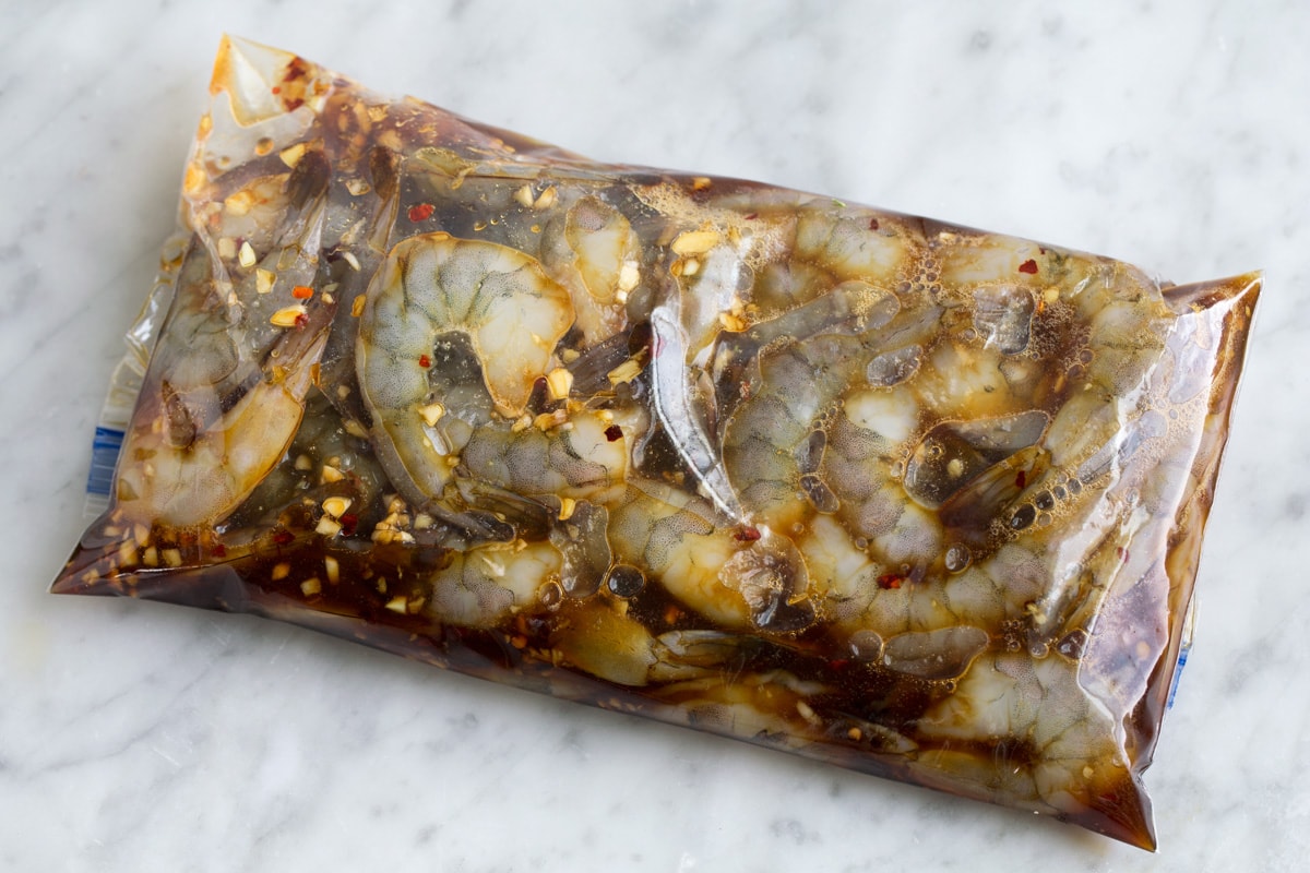 Shrimp in marinade in a plastic resealable bag.