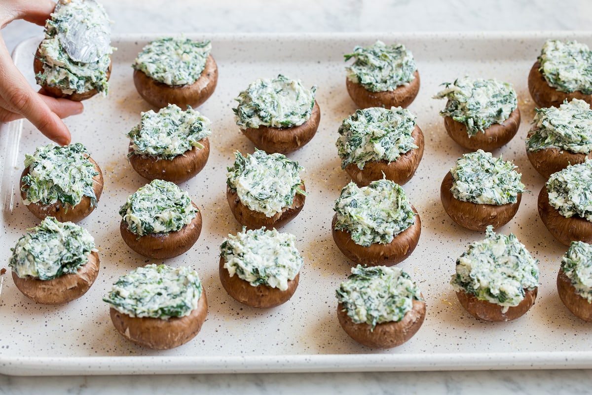 Filling mushroom caps with cheese filling.