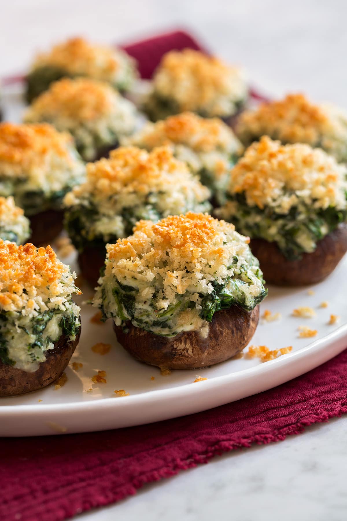 Stuffed Mushrooms sitting on a white platter.