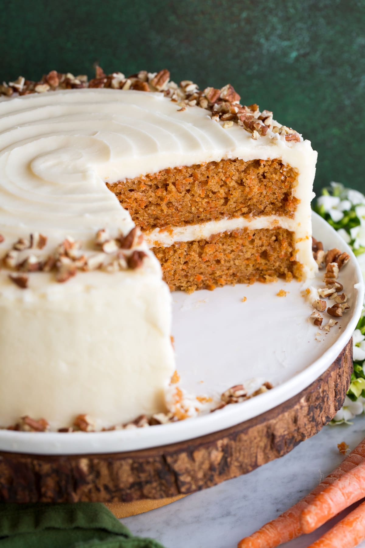 Close up image of carrot cake, sliced into to show interior.