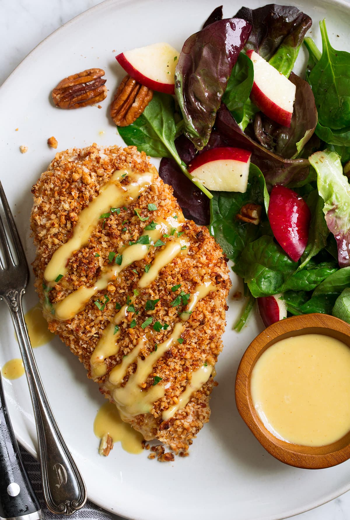 Pecan chicken with honey mustard glaze with a side salad on the side.