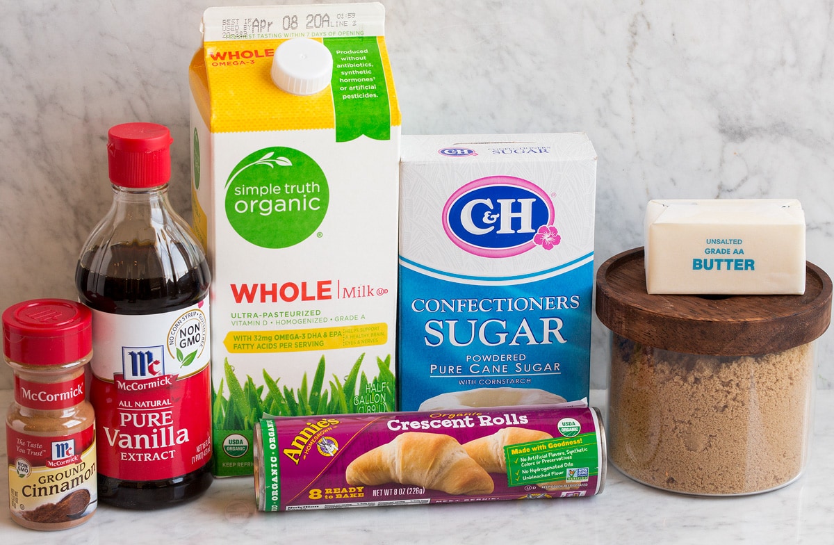 Photo of ingredients used to make mini cinnamon rolls. Includes crescent dough, brown sugar, butter, powdered sugar, milk, vanilla and cinnamon.