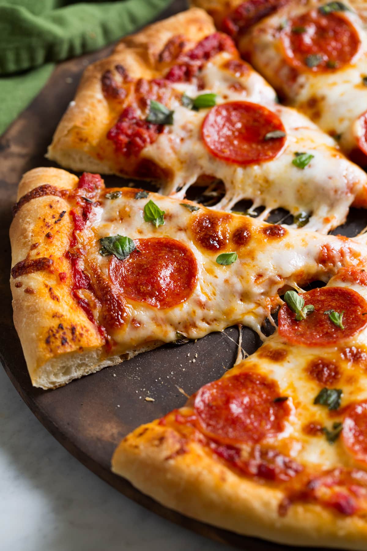 Slices of pepperoni pizza made with a homemade pizza dough recipe.
