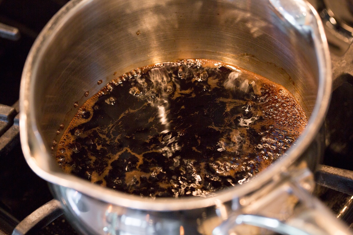 Balsamic vinegar simmering in a small saucepan.