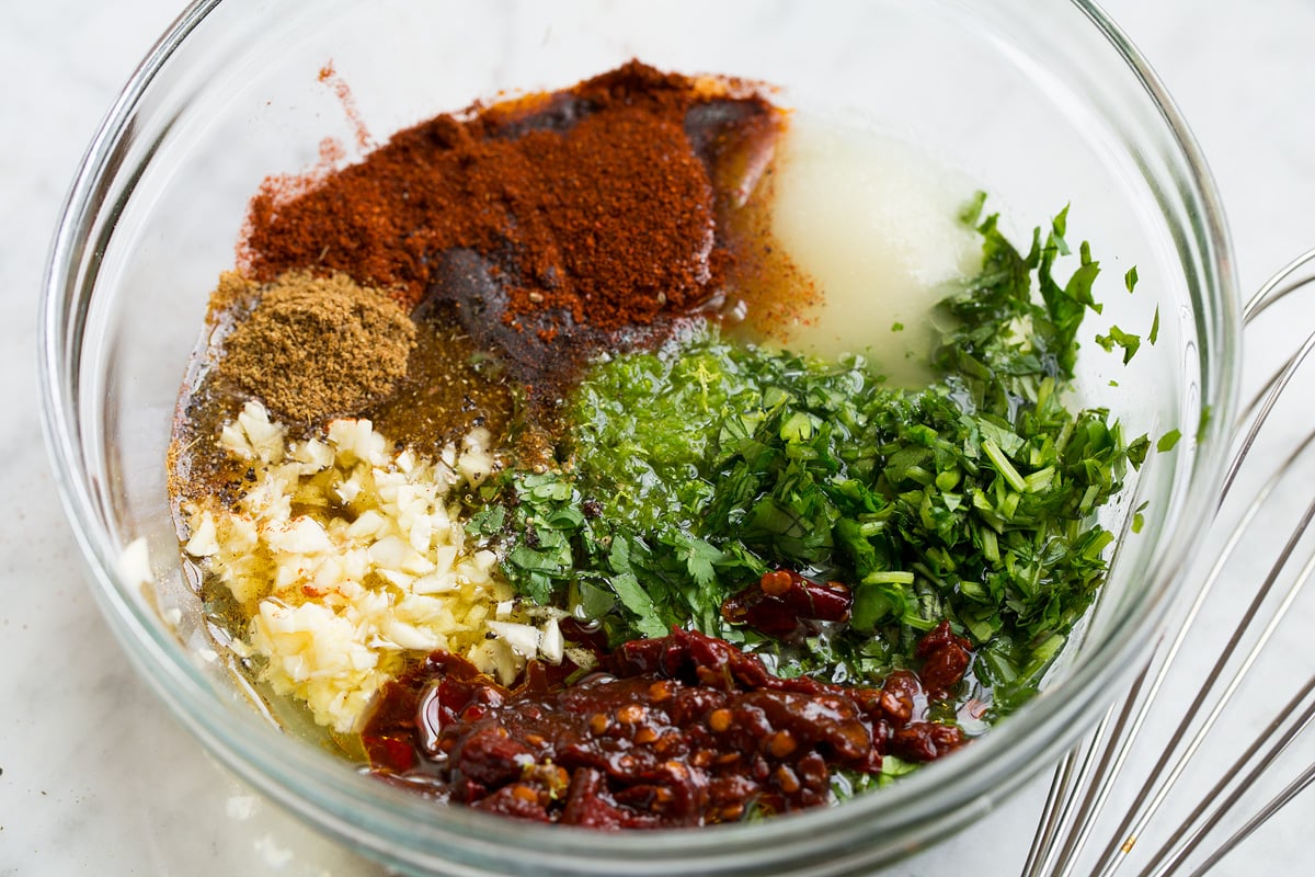 Carne asada marinade in a glass mixing bowl shown before mixing.