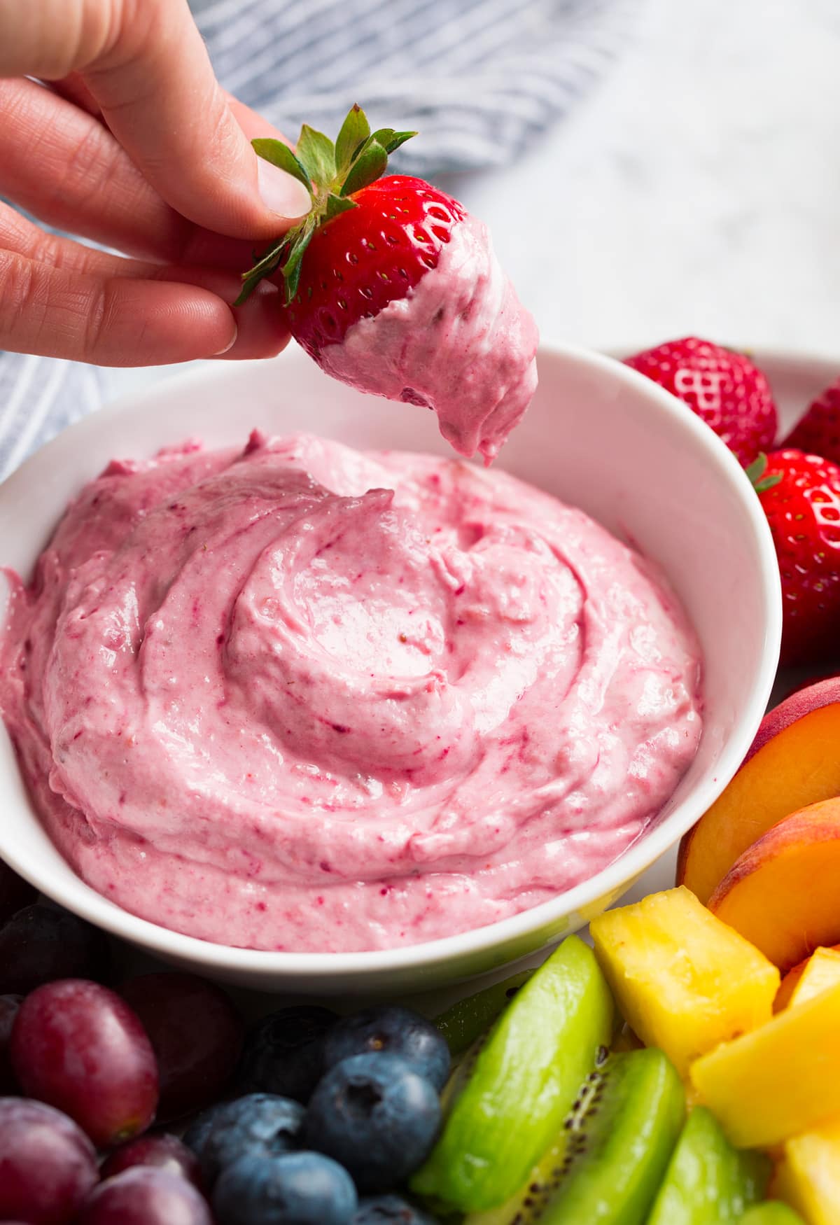 Strawberry shown after dipping in cream cheese fruit dip.