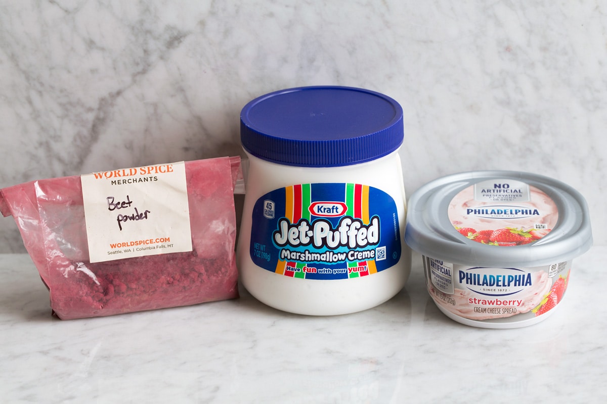 Image of 2 ingredients used to make fruit dip, marshmallow fluff plus cream cheese. Plus also shows optional beet powder to tint fruit dip. 