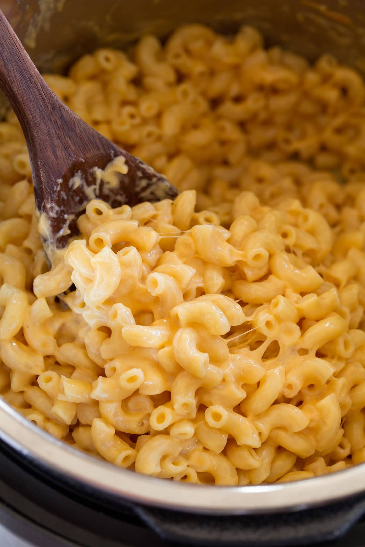 Close up image of mac and cheese being scooped from Instant Pot.