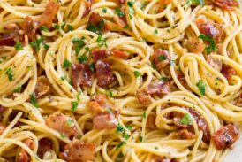 Pasta carbonara shown in a large white serving bowl.