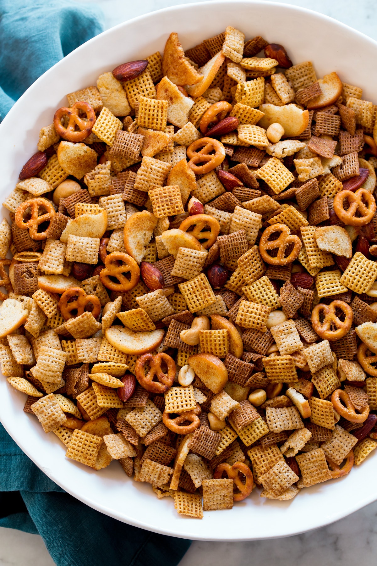 Chex Mix shown from overhead in a big white bowl.