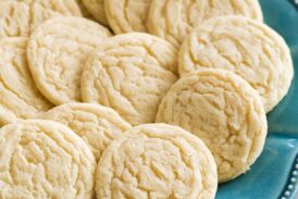 Classic homemade sugar cookies shown on a turquoise plate