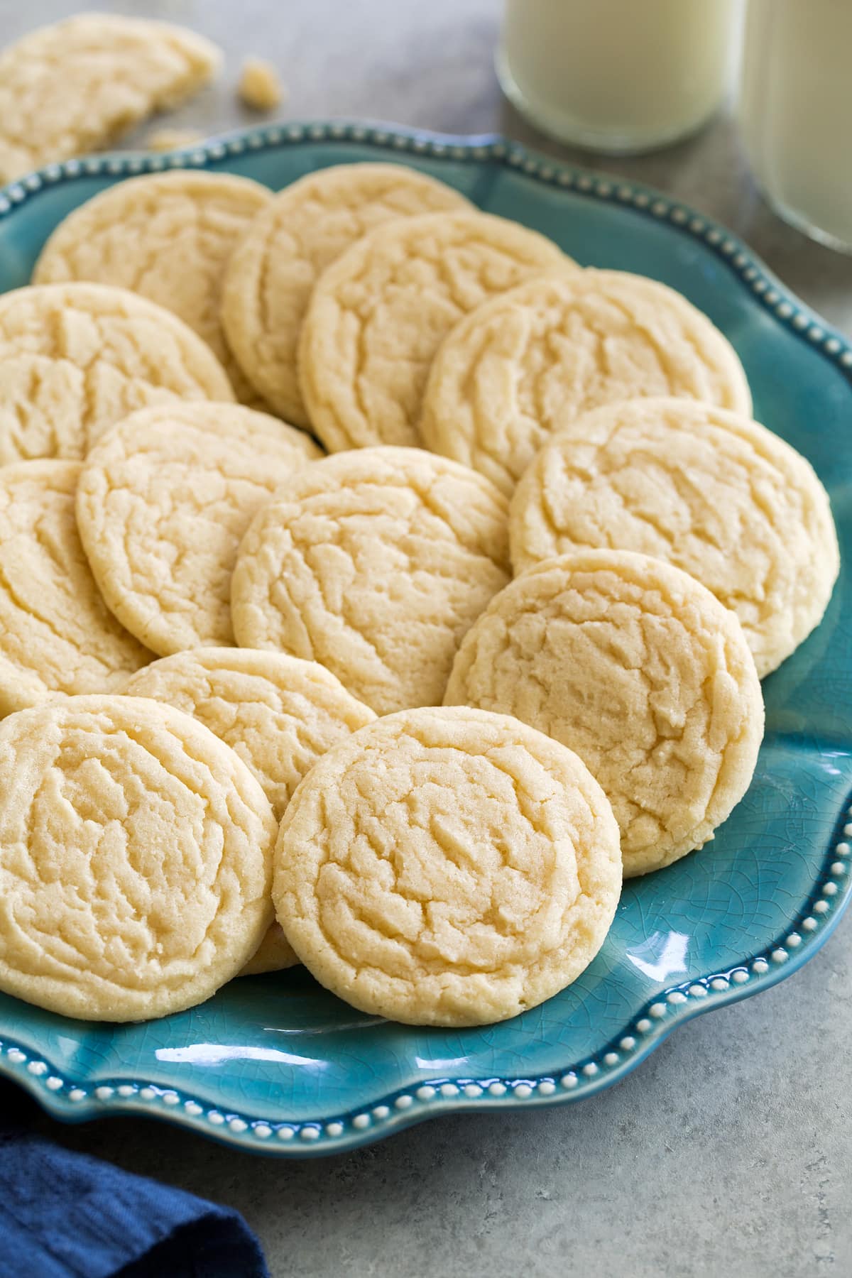 Classic homemade sugar cookies shown on a turquoise plate