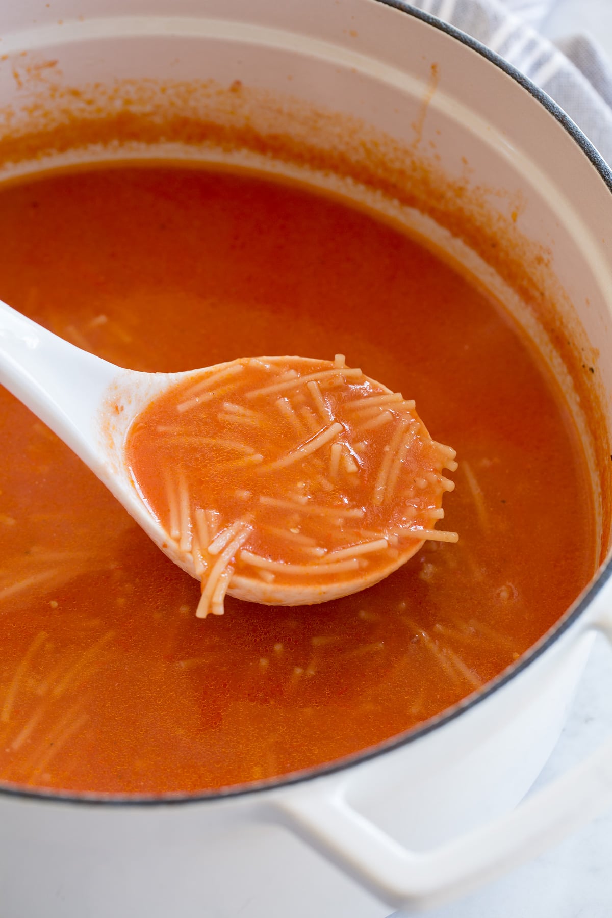 Ladle full of sopa de fideo.