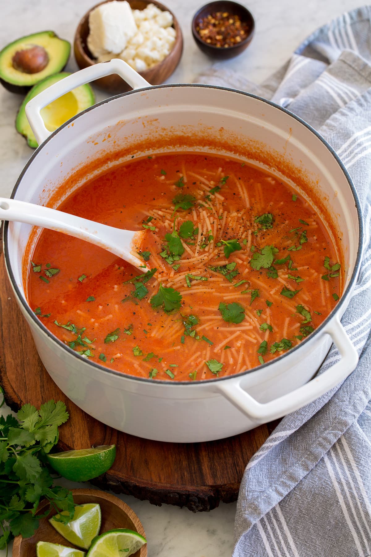 Pot of sopa de fideo with cilantro garnish.
