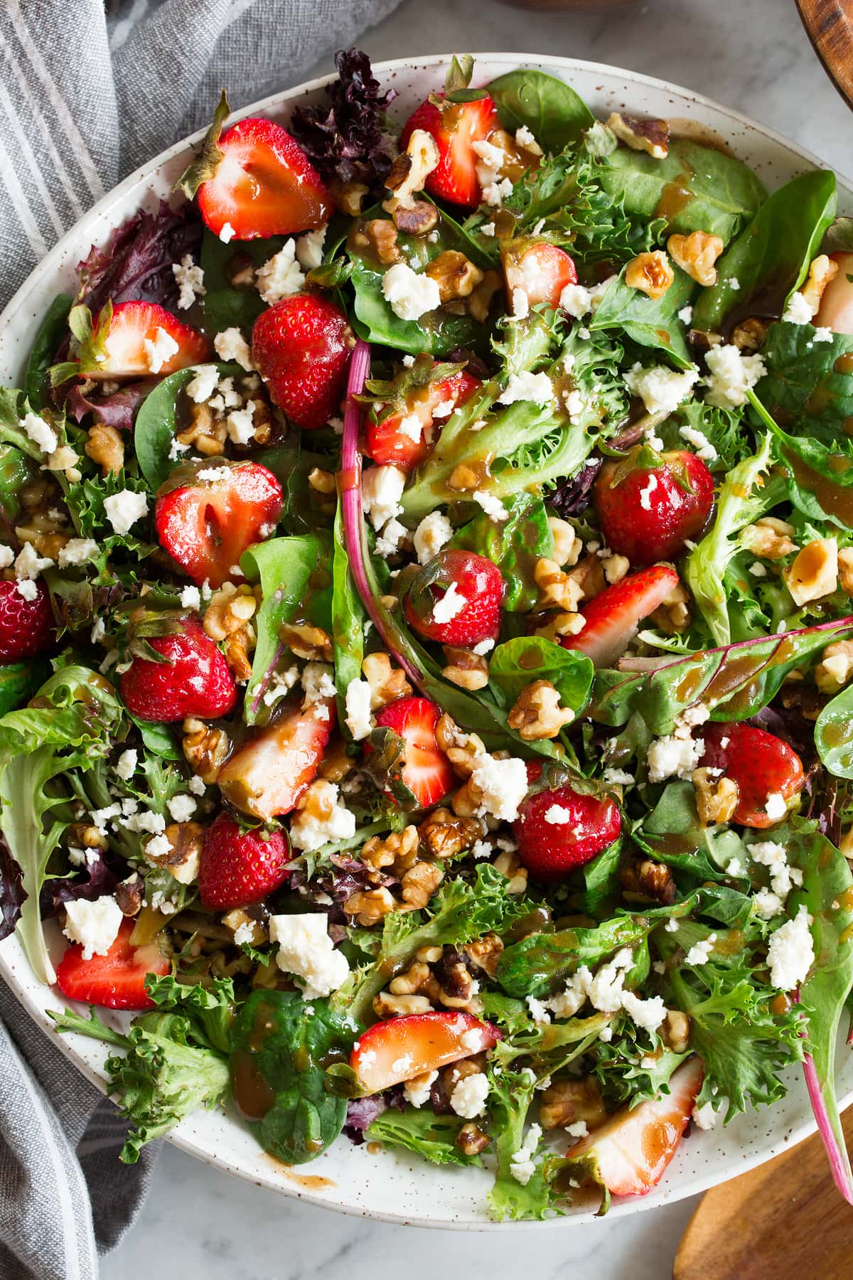 Close up photo of salad drizzled with balsamic vinaigrette dressing.