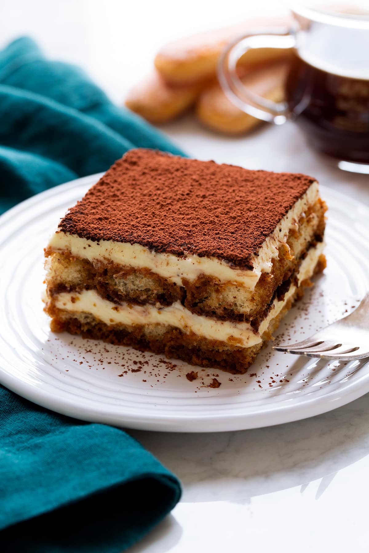 Slice of homemade tiramisu on a dessert plate.