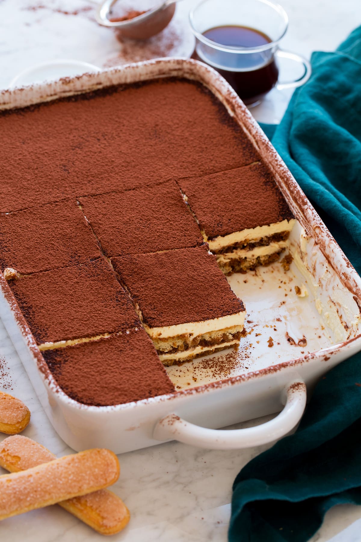 A baking dish filled with tiramisu cut into slices.