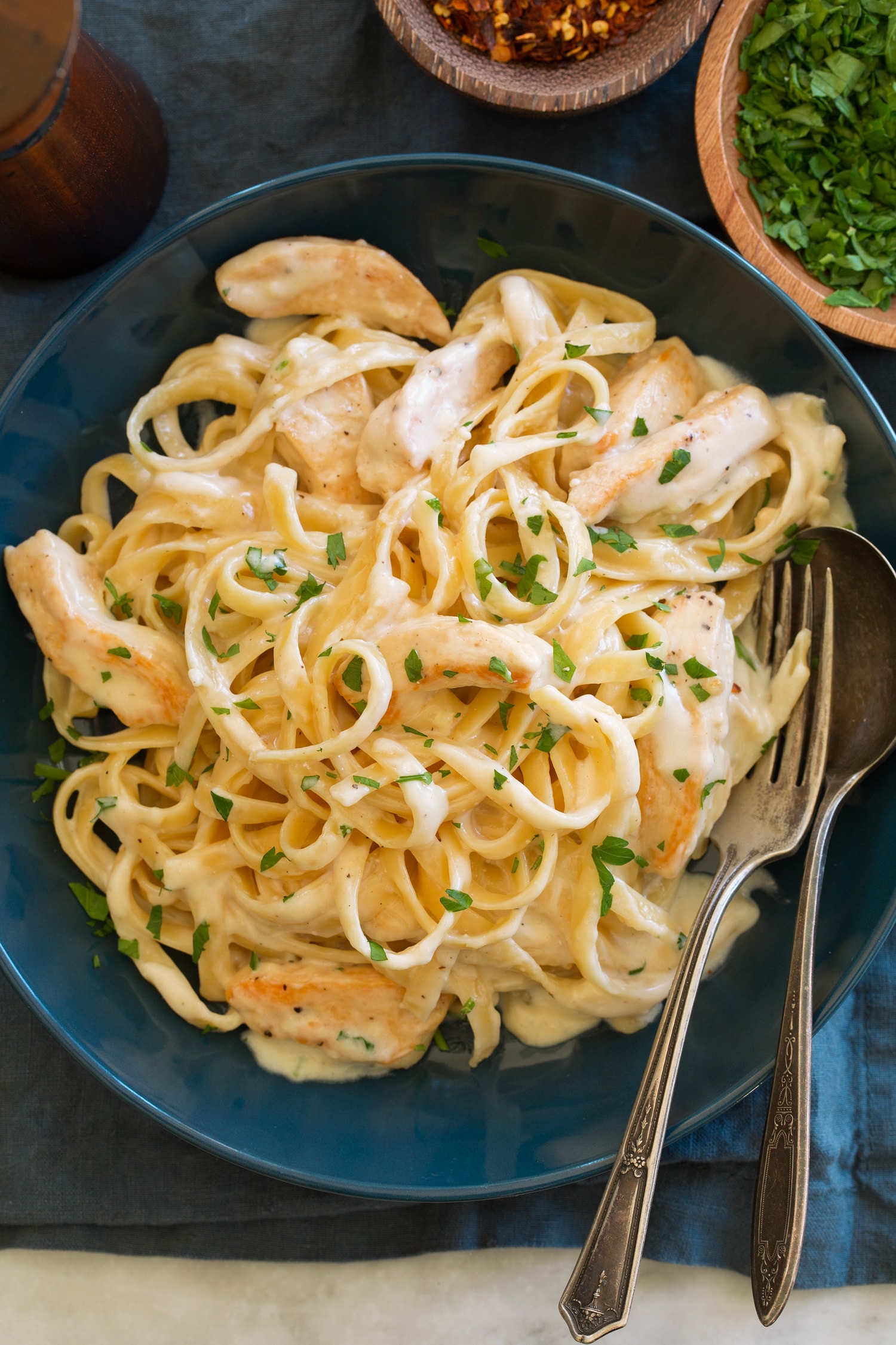 Overhead photo of chicken alfredo in blue bowl.