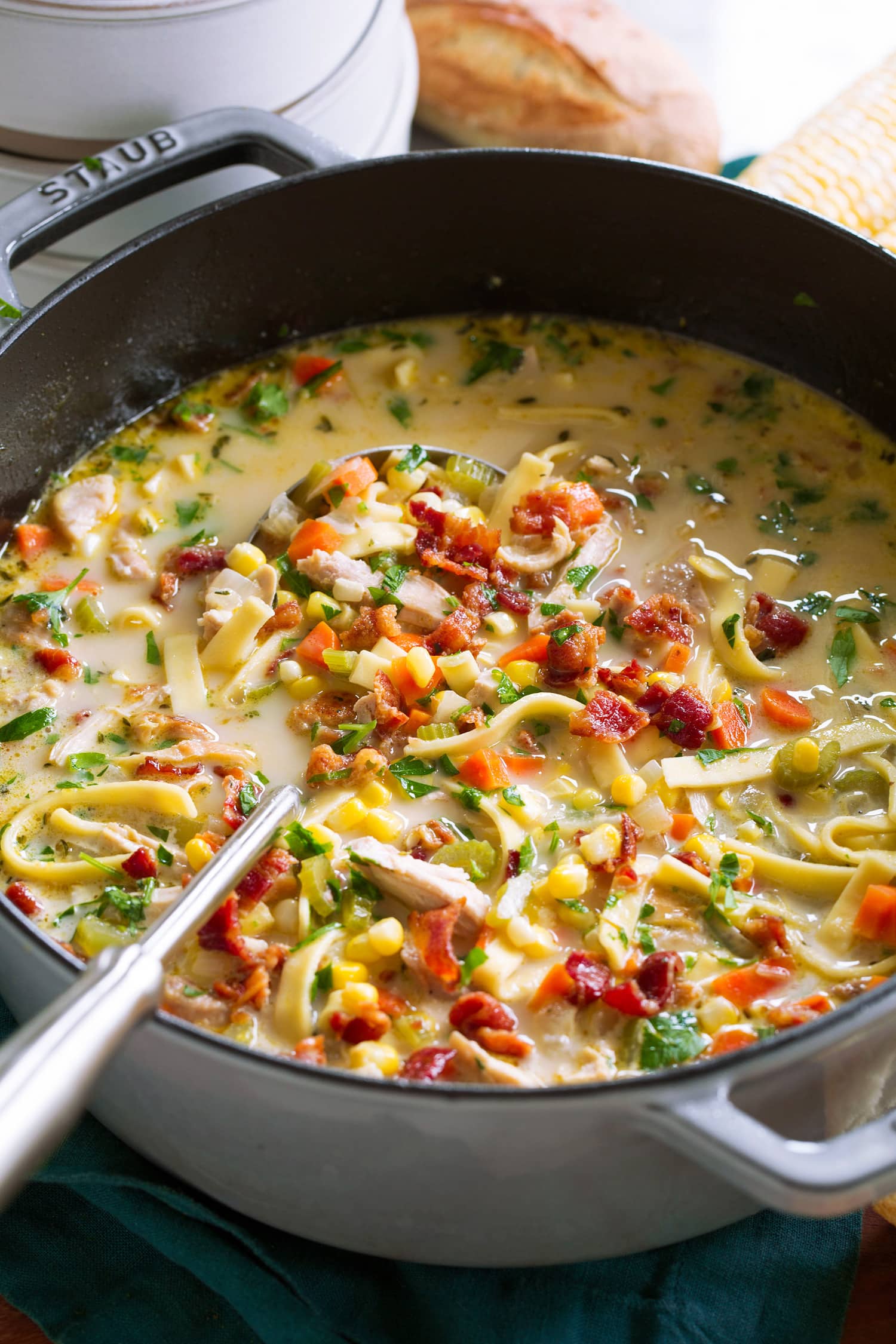 Close up picture of chicken noodle corn soup.