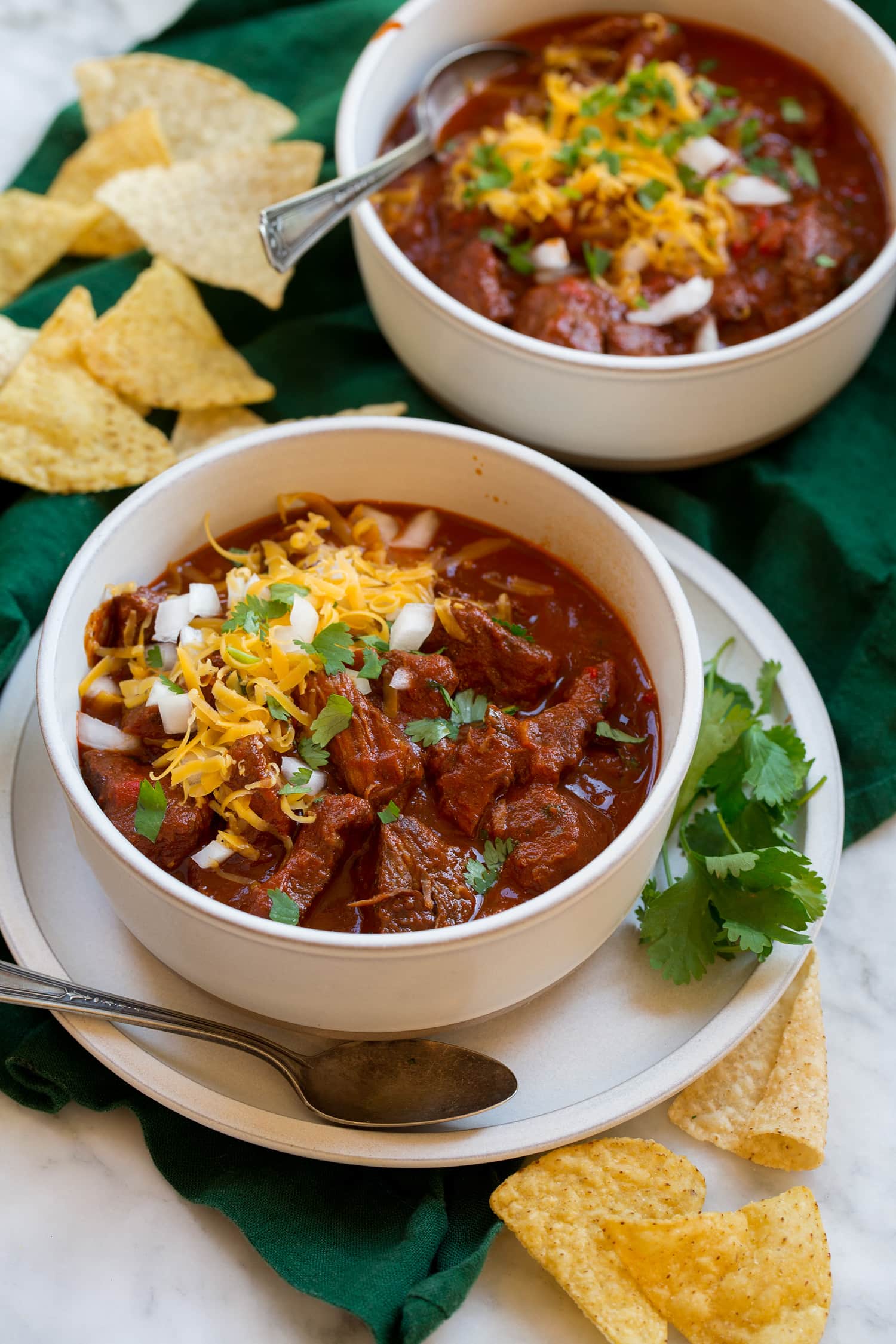Two servings of homemade chili con carne with chuck roast and dried peppers.