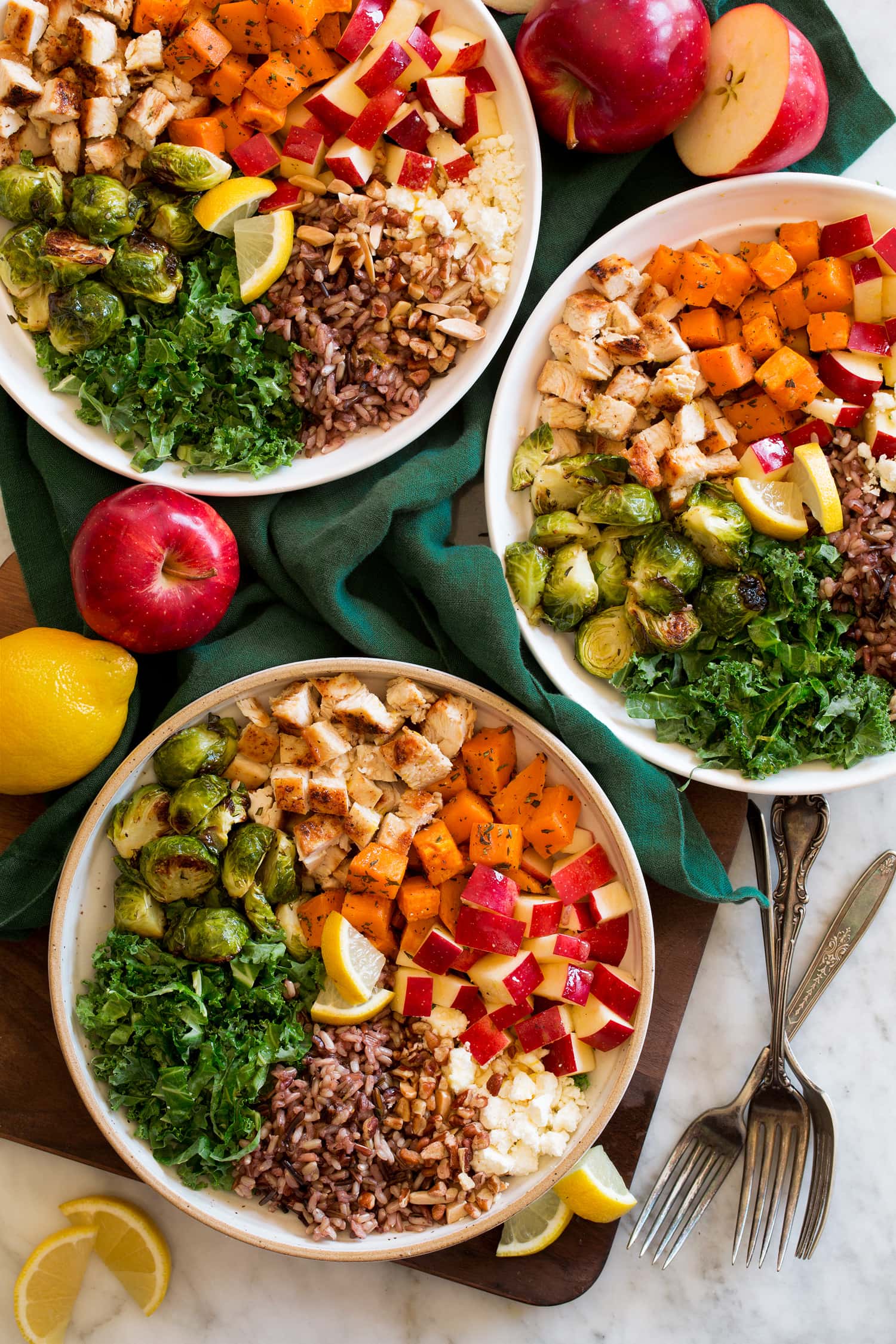 Harvest bowls with sweet potatoes, kale, chicken, nuts, feta, apples and wild rice.
