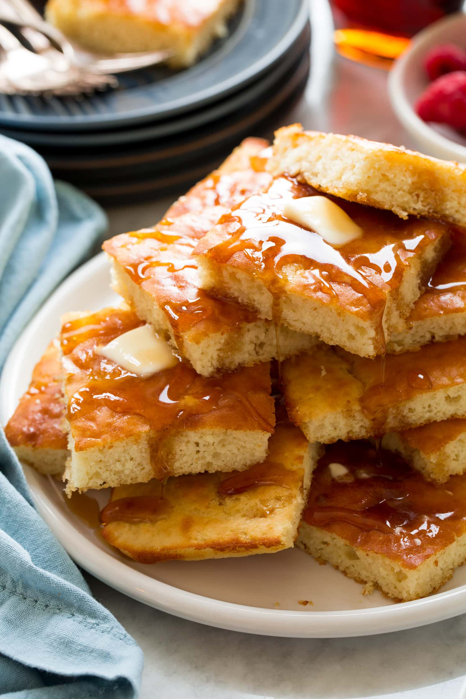Tall stack of sheet pan pancakes shown close up.