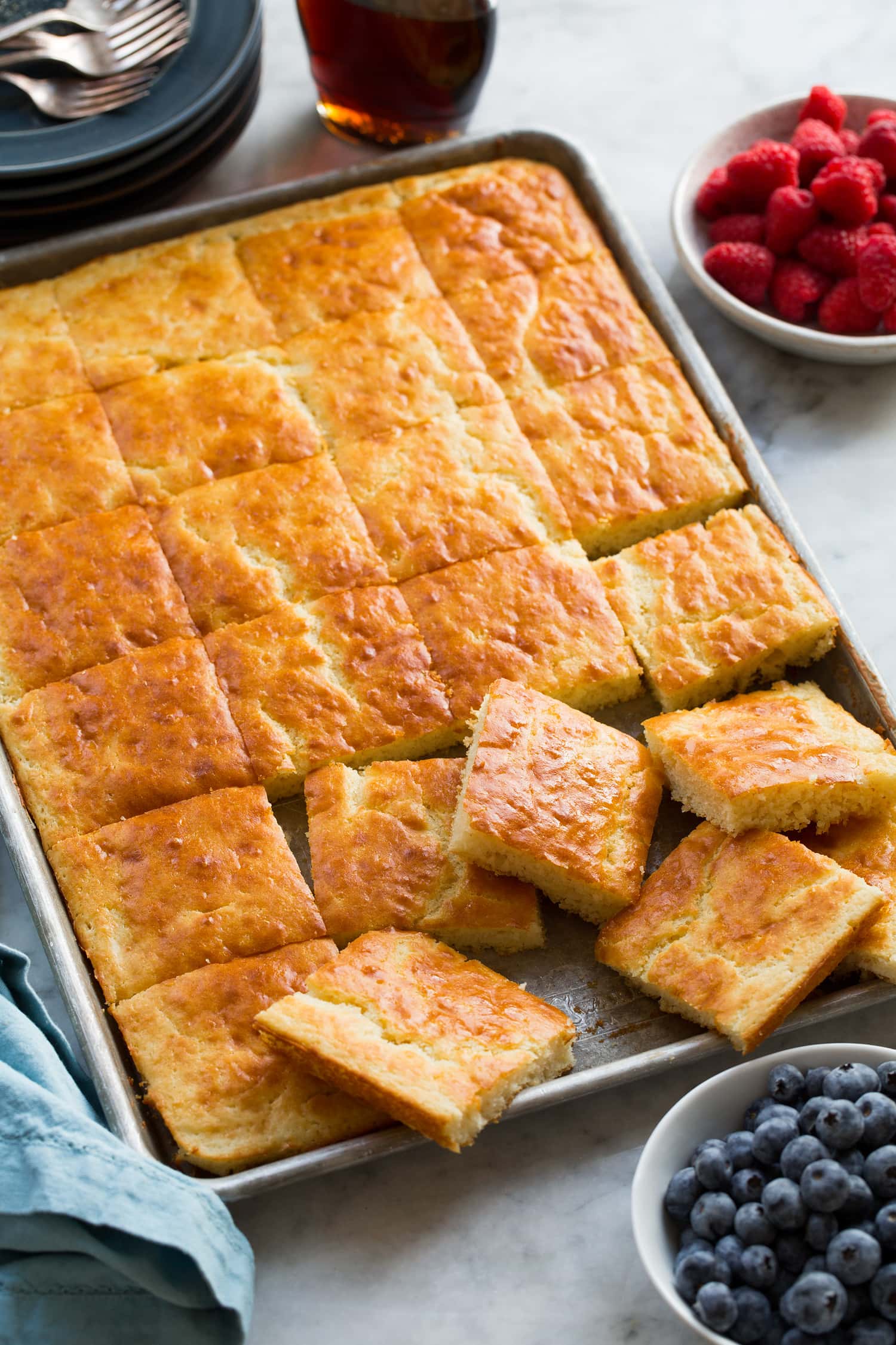Pancakes shown cut into squares in baking sheet.