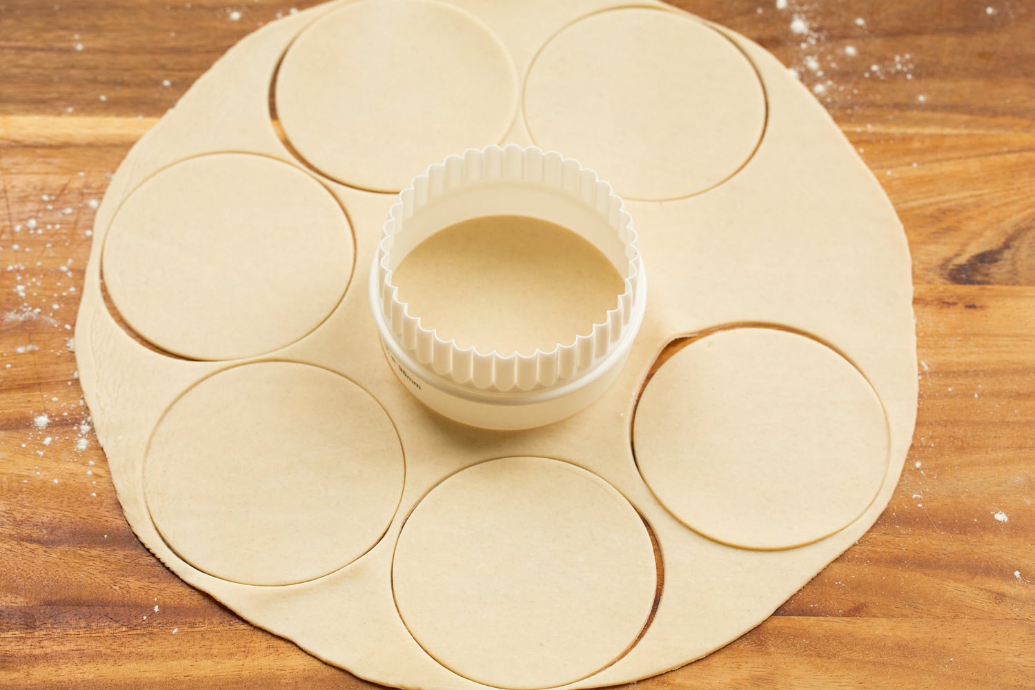 Cutting pie crust into rounds.